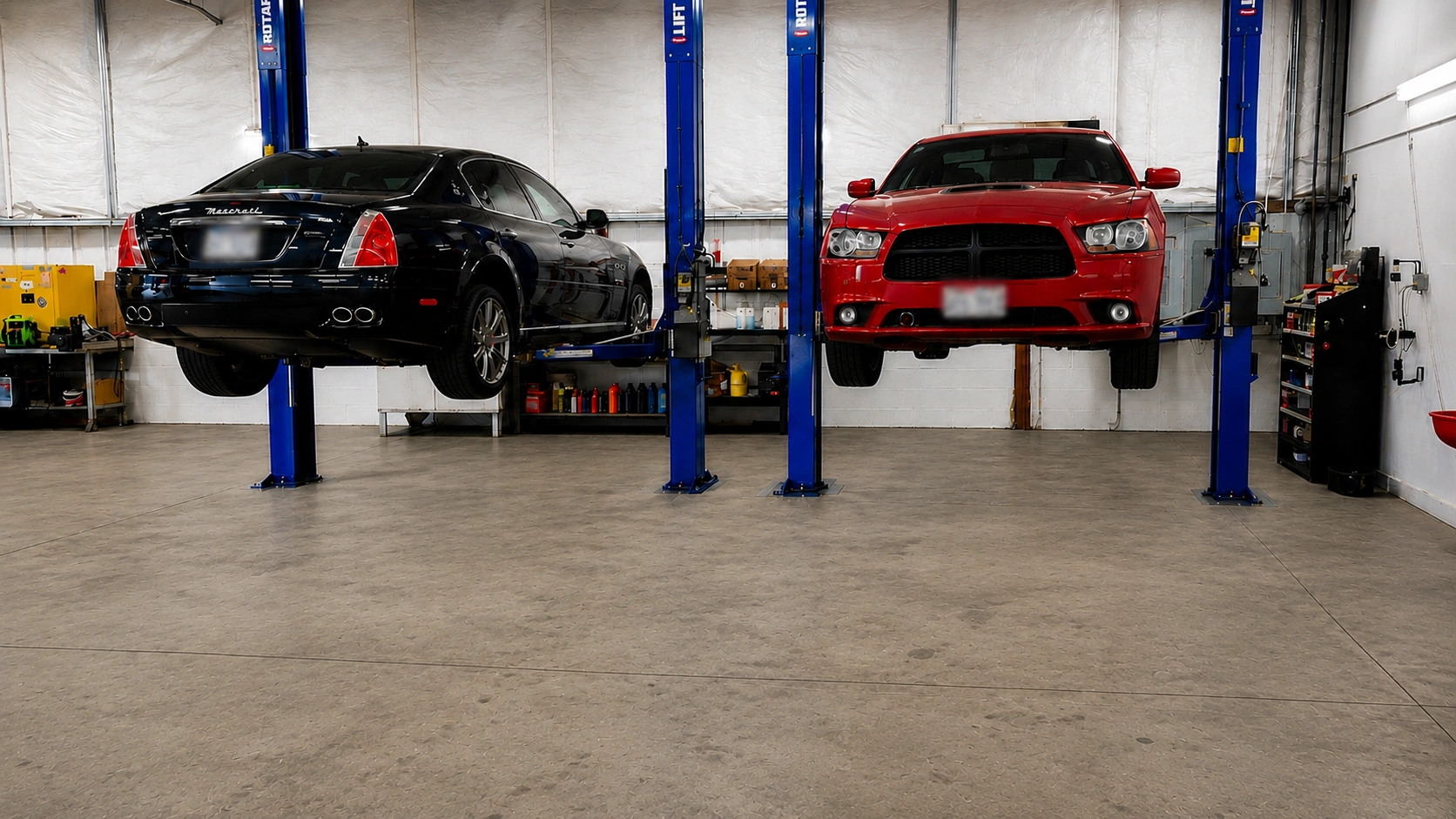 Maserati and Dodge Charger on lifts
